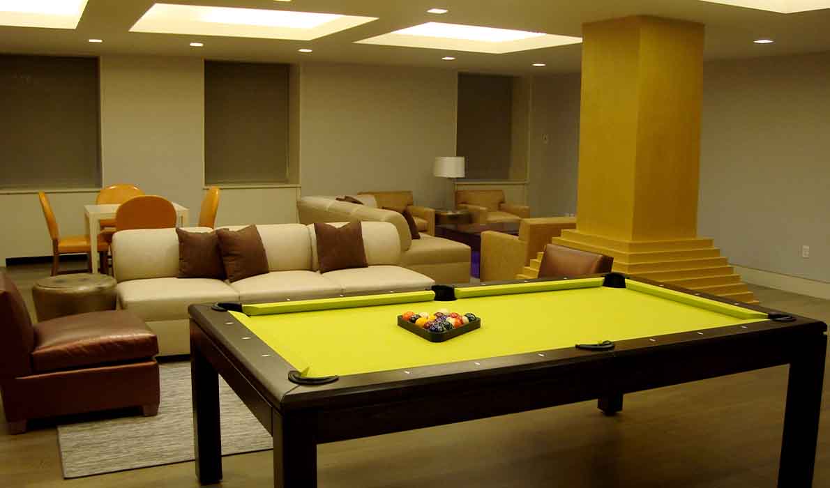 Luxury common area with billiards table, modern seating, and ambient lighting at 390 West End Avenue apartments in NYC. Designed and built by Universal Management & Contracting Corp.