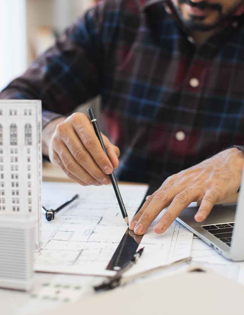 Construction estimator from Universal Management & Contracting analyzing building plans for NYC project estimate