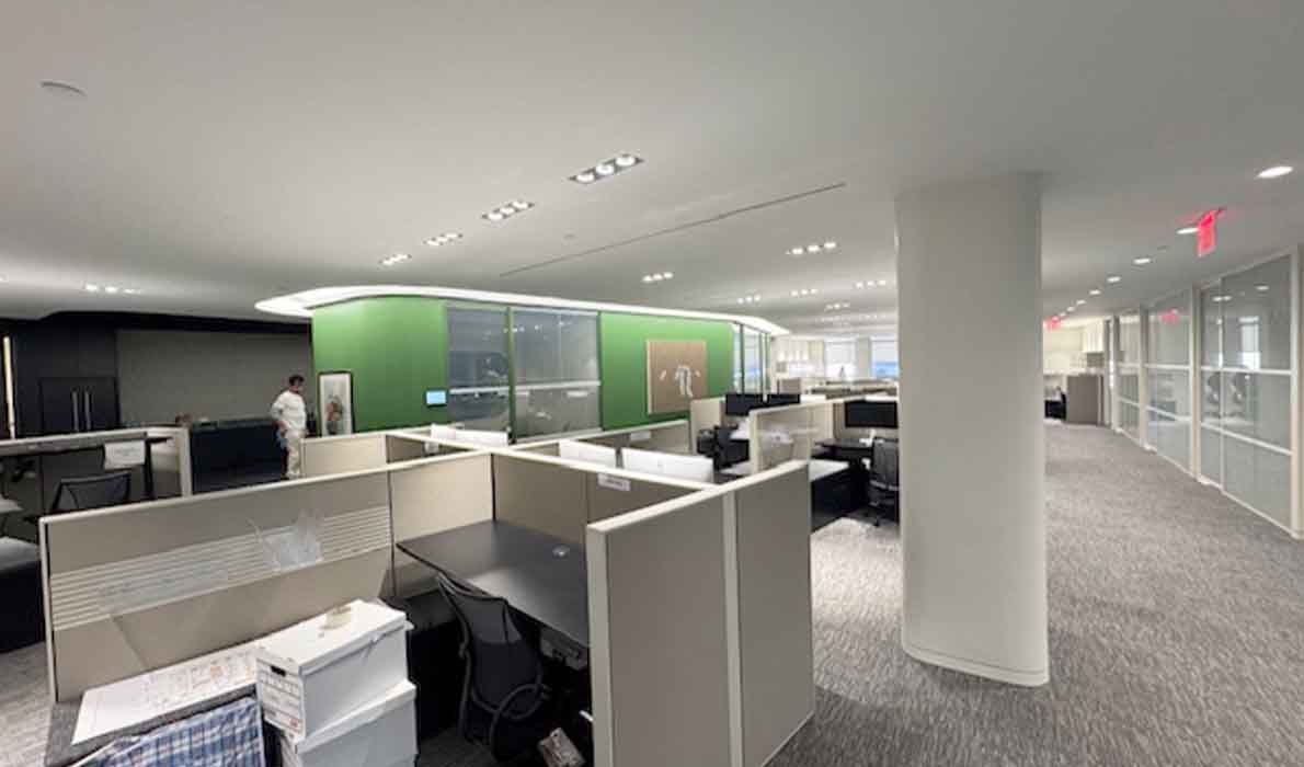 Renovated modern office interior at 370 7th Avenue designed by Universal Contracting and Management, featuring open workstations, glass partitions, and contemporary corporate design.